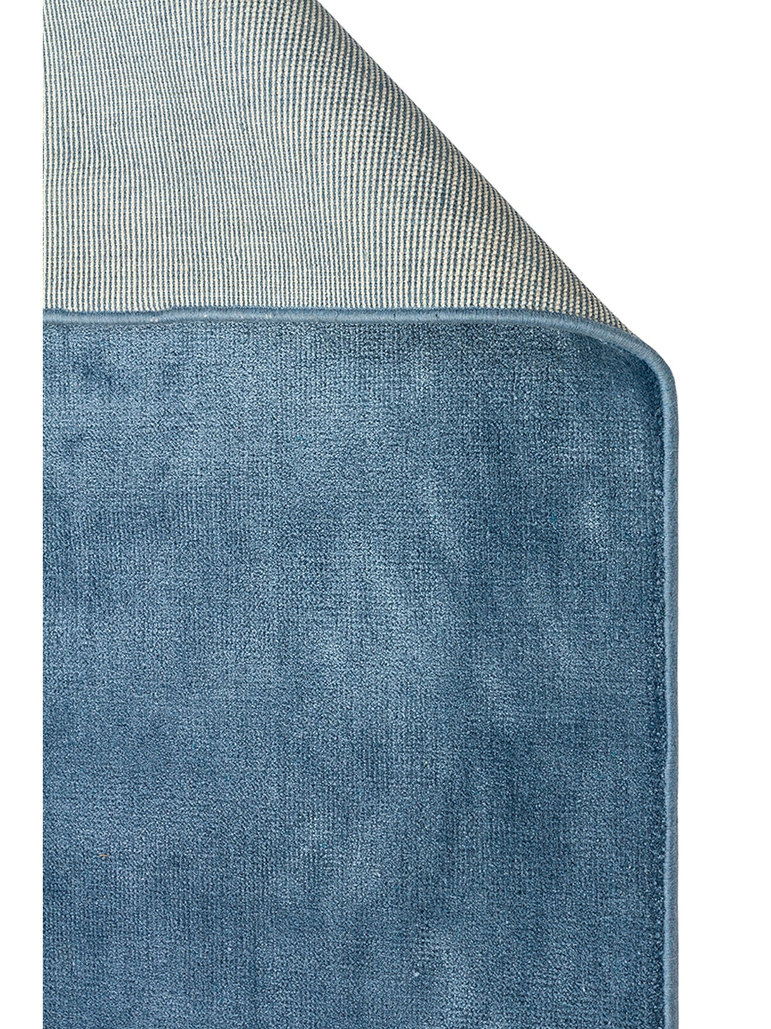 Blue modern rug corner detail showcasing its soft texture and subtle sheen.